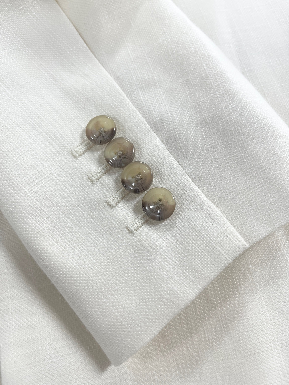 Luxury white textured suit fabric with sleeve buttons for formal custom menswear in Jacksonville Florida#weddingsuit #customsuit #italianfabric #jacksonvilleflorida #mensfashion