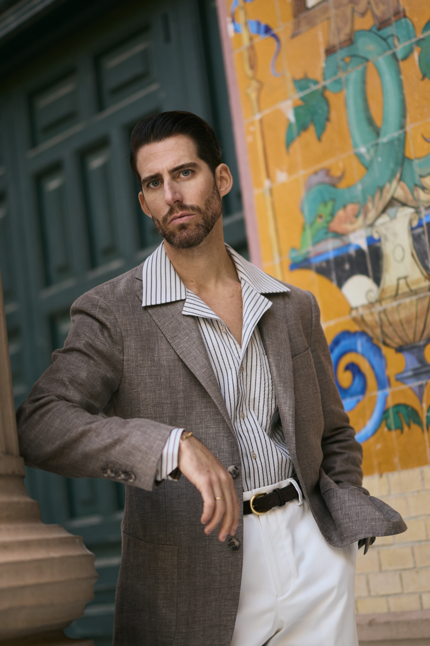 Man wearing a relaxed brown sport coat with striped shirt and white trousers in Jacksonville styled for modern business casual #mensfashion #customsuit #jacksonvillefl #businesscasual #zanesuitclub
