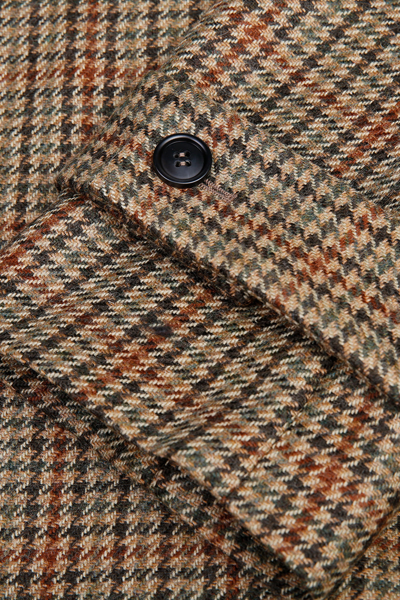 Close-up of a textured fabric with a button, featuring earthy tones. new york style overcoats for winter women coat