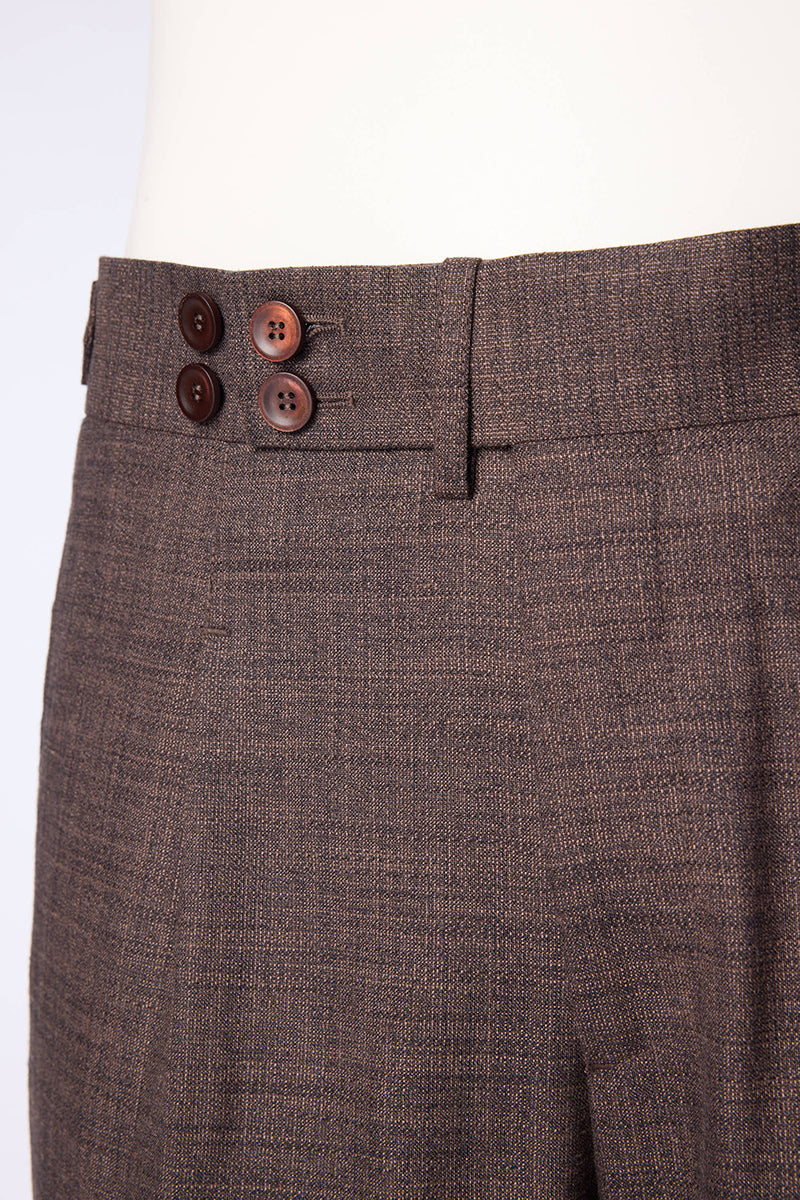 Men's brown textured dress pants featuring a pleated front design, side waist adjusters, and an extended button tab closure for a tailored, polished look. Crafted from a luxurious blend of bamboo, wool, silk, and spandex, these trousers offer natural stretch, breathability, and a soft drape, making them ideal for formal business settings, wedding attire, or upscale casual events. Styled to pair seamlessly with blazers, dress shirts, or knitwear, these pants are perfect for the modern gentleman seeking versa
