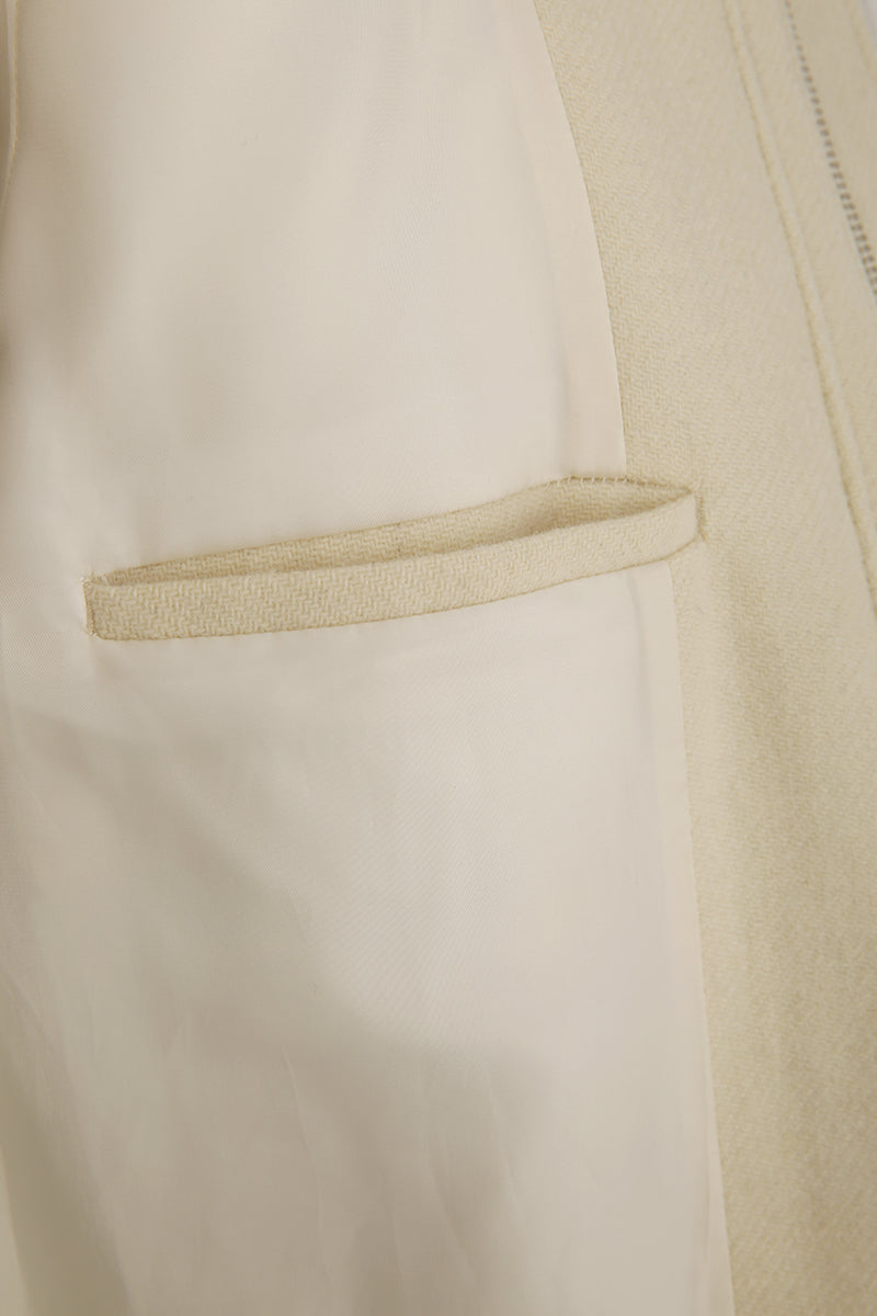 Close-up of a beige fabric with a pocket detail