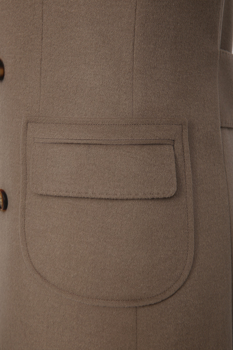 Close-up of a brown coat with a pocket
