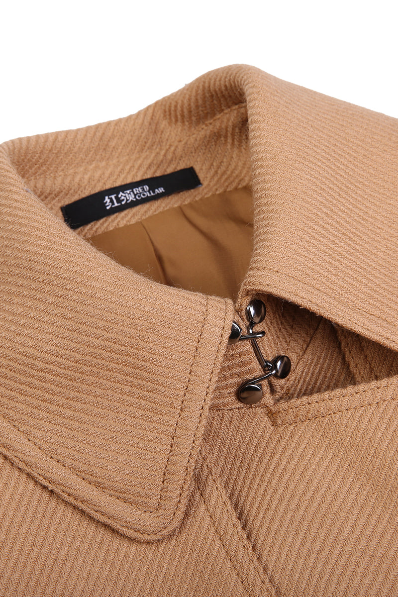 Close-up of a brown coat collar with a brand label on a white background