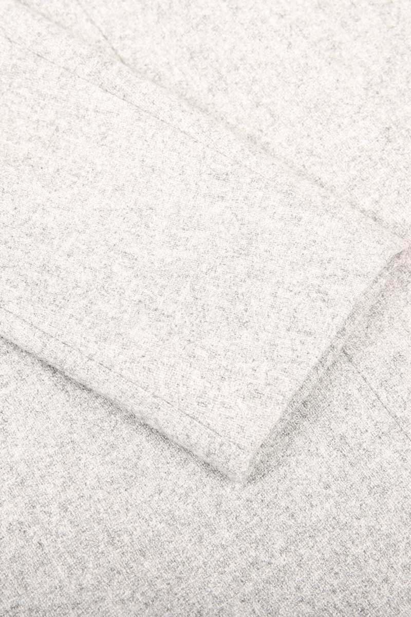 Close-up of a textured white fabric with a diagonal pattern