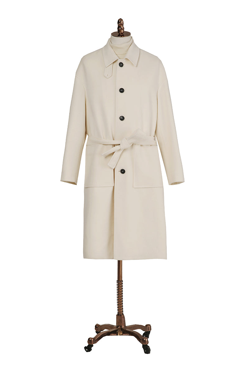 Beige trench coat on a mannequin against a white background