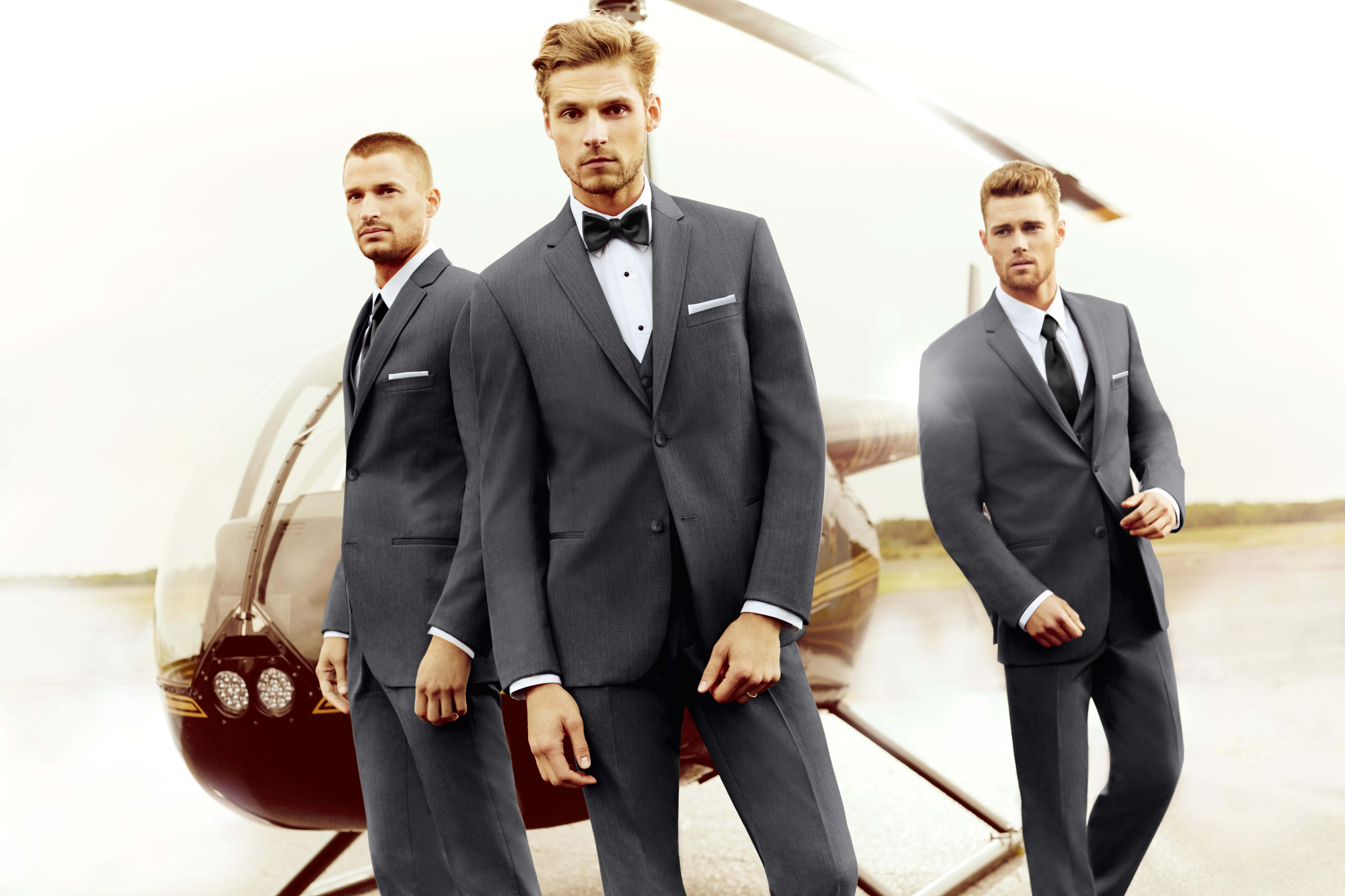 Tuxedo rental from Zane featuring modern fit black jacket with satin lapel, dress shirt, and bow tie, available for weddings and prom with shipping across the U.S.