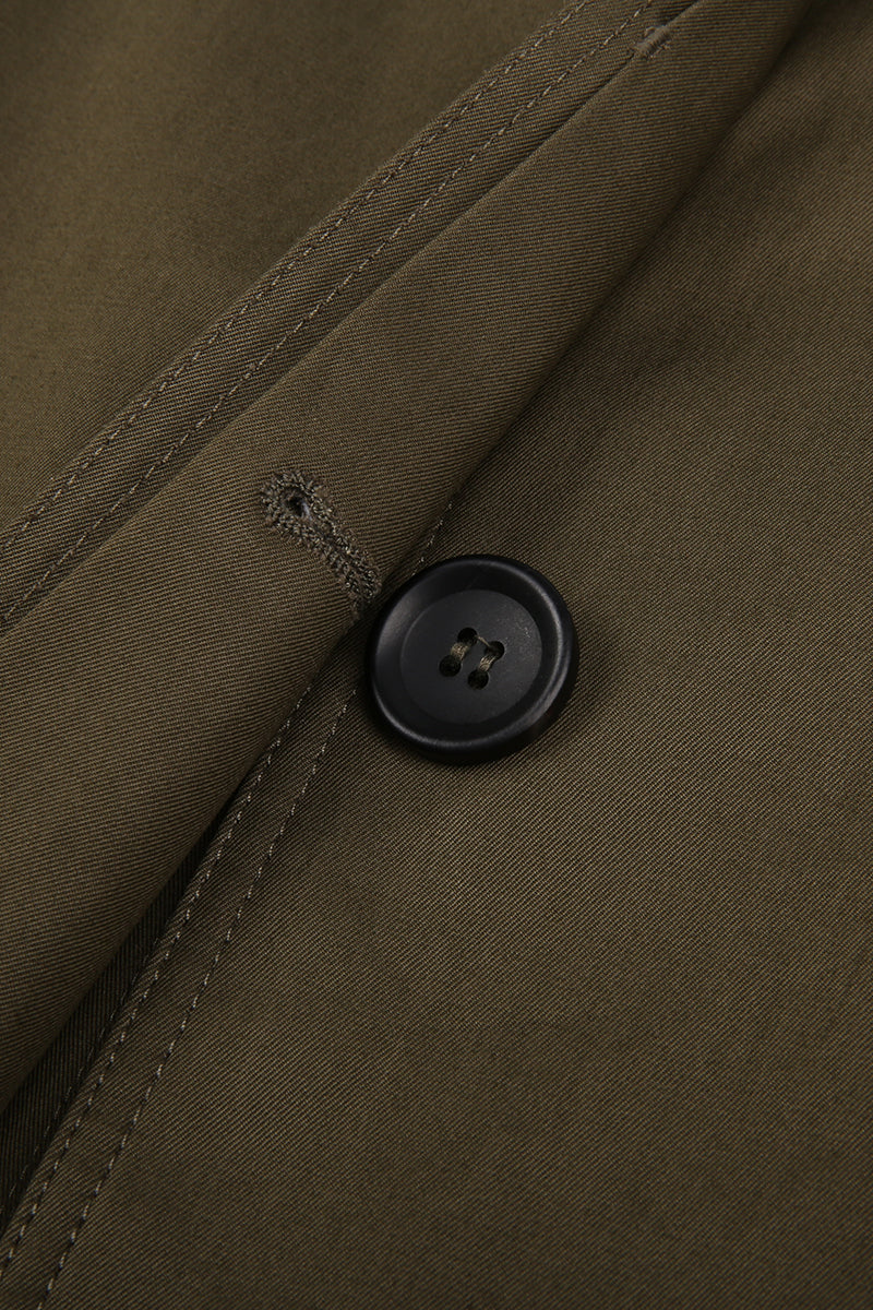 Close-up of a button on a brown jacket with visible stitching.