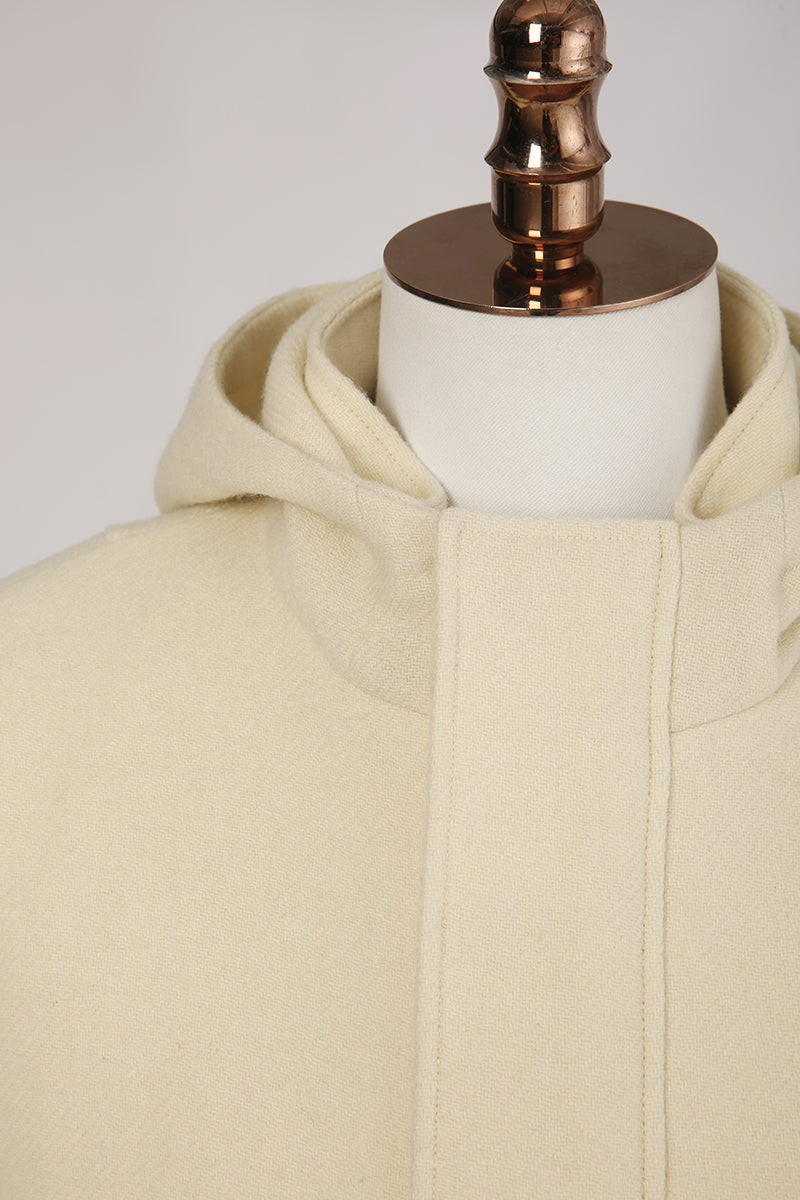 Beige hooded jacket on a mannequin with a white background