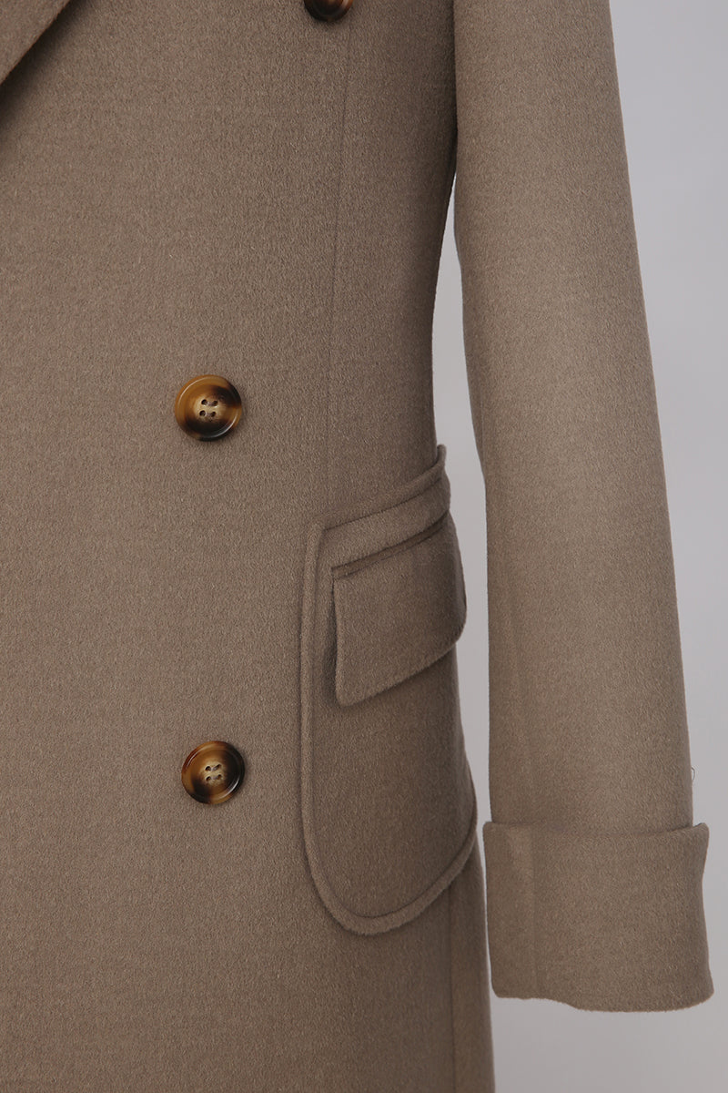 Close-up of a brown coat with buttons and a pocket on a light gray background