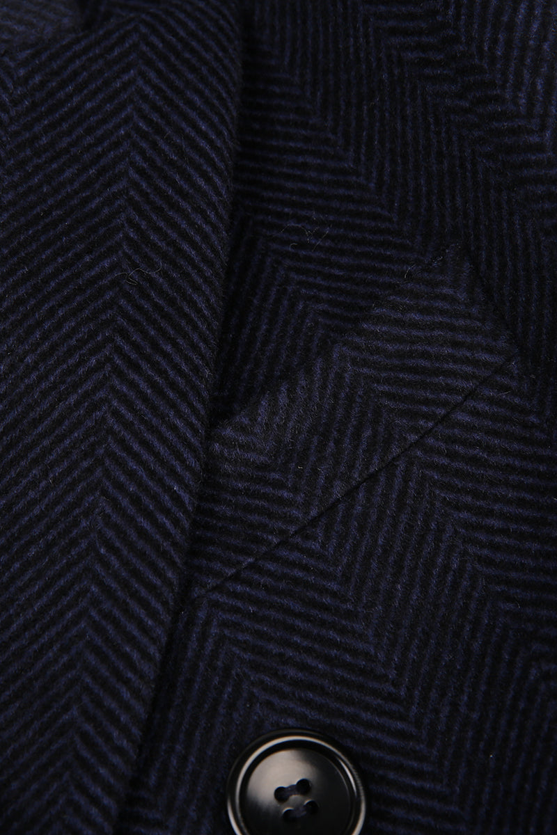 Close-up of a dark blue textured fabric with a button