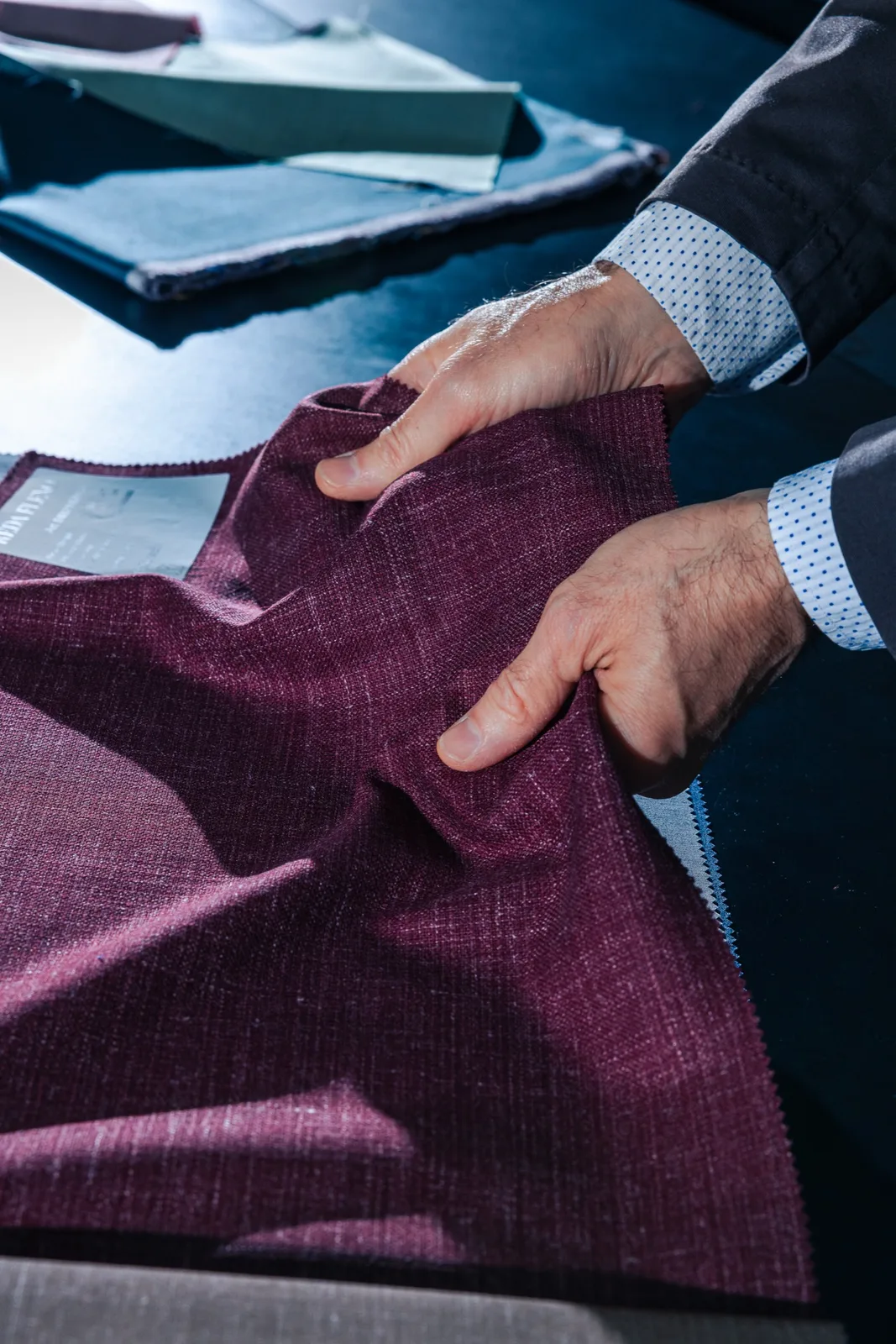 Tailor taking measurements for a custom suit at a client's home in Jacksonville